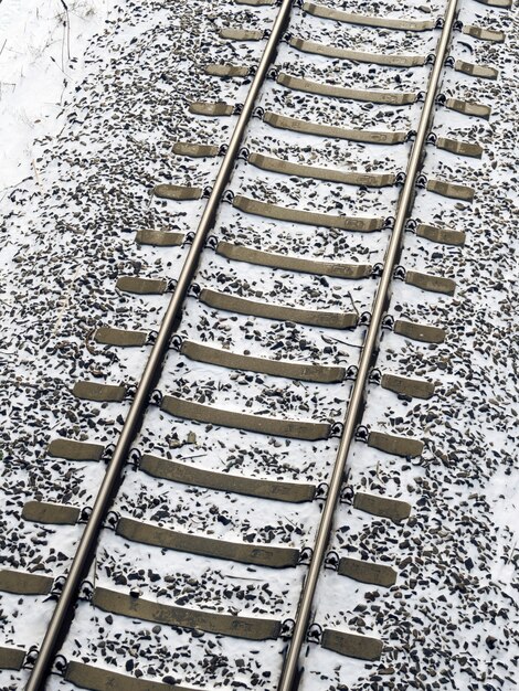 Railway tracks fragment covered by fresh snow