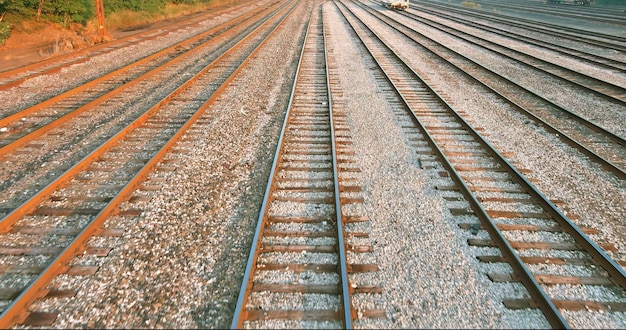 Railway tracks the way forward railroad line cargo platform at sunrise morning viewed