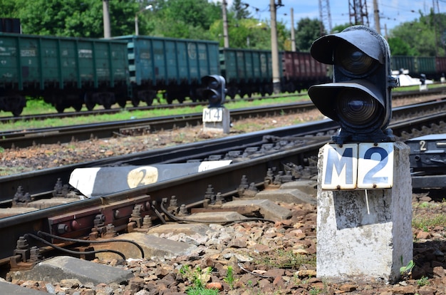 Railway traffic light (semaphore) against the background of a day railway landscape. 