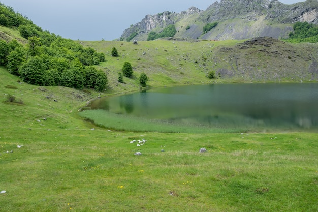 Rain clouds are approaching the mountain lake.