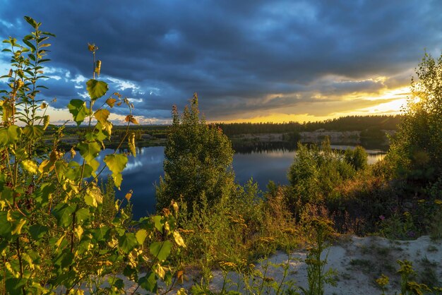 Rain clouds hang over the reservoir at sunset Vsevolozhsk Leningrad region