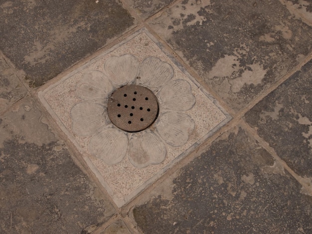 Rain drain in old paving.