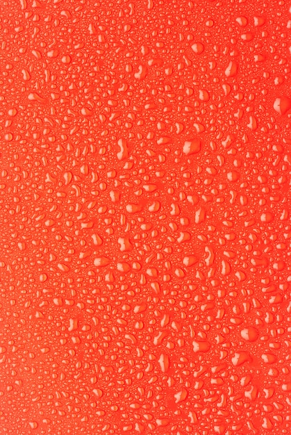 Rain droplets on a red plastic background