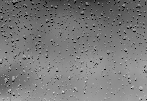 Rain Drops on black Glass as Background