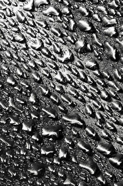 Photo rain drops on dark grey metallic wall