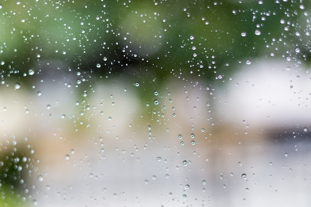 透明なガラスの表面に雨が降りる