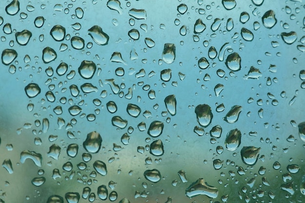 Rain drops on the window in rainy day. View from building.  Nature background concept.