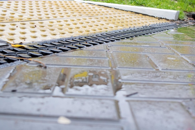 Rain grate on the sidewalk in the rain