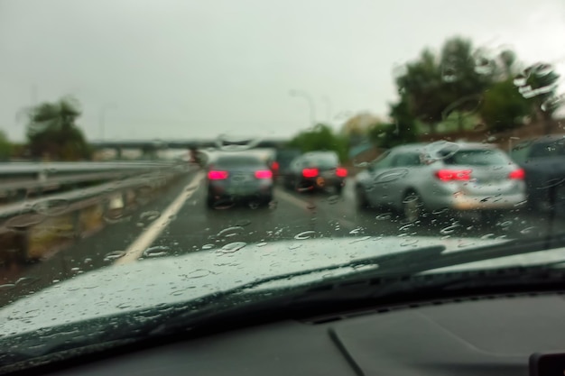 Rain that falls heavily on cars driving on the highway in the direction of the city