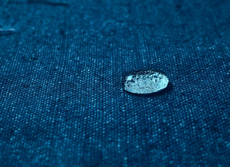 Photo rain water droplets on blue waterproof fabric.