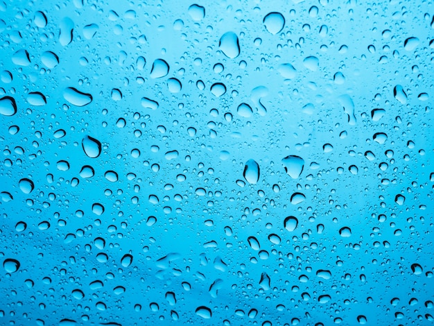 Rain water Drops On blue Background.