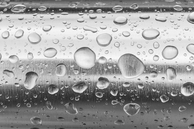 Rain water drops on a stainless steel surface Water art background