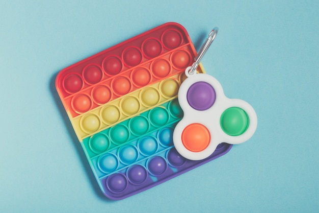 Rainbow antistress toys Pop It and Simple Dimple for the development of fine motor skills