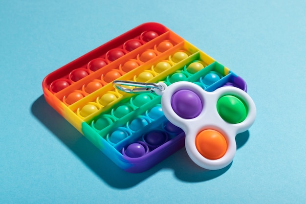 Rainbow antistress toys Pop It and Simple Dimple for the development of fine motor skills