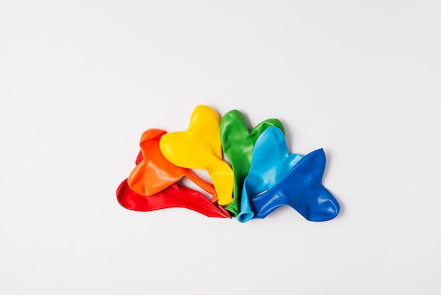 Rainbow balloon hearts for decoration in LGBT colors Set of isolated heart shaped deflated balloons