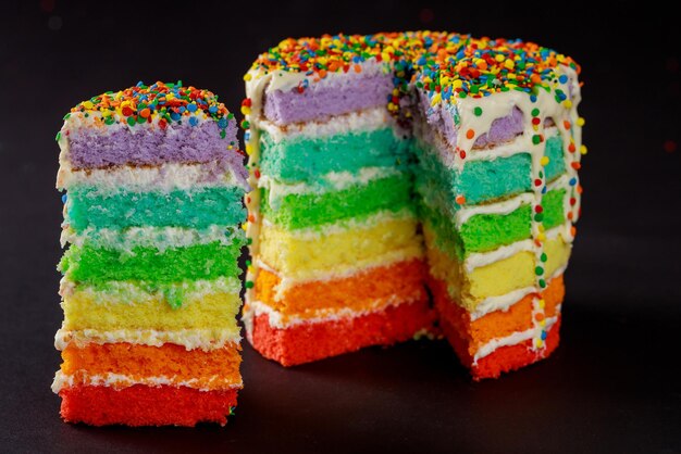 Torta di compleanno arcobaleno con spruzzi di colore.