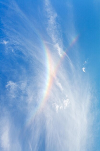 Rainbow in blue summer sky