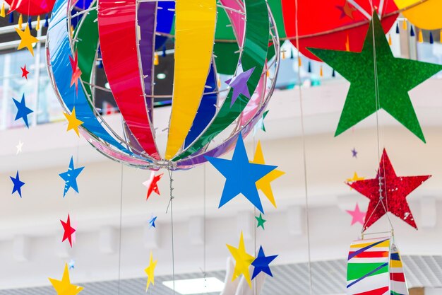 Rainbow circus tent roof with colorful decorations at carnival\
or amusement park