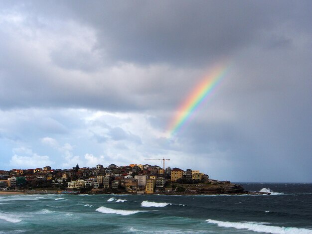 Rainbow over city at seaside