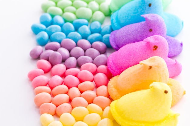 Rainbow color marshmallow peeps and jelly beans.