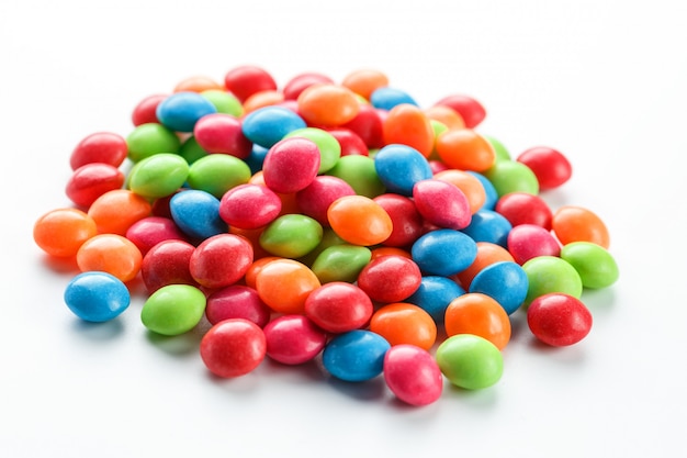 Rainbow-colored candies on white background