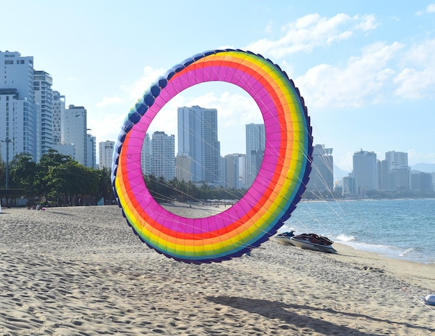 Rainbow colored kite on sandy beach in Vietnam