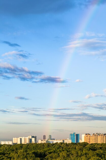 rainbow in evening sky over apartment buildings