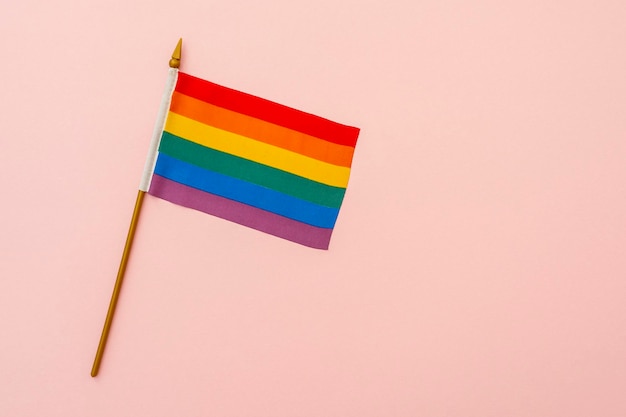 Rainbow flag as symbol of tolerance and LGBT on pink background concept picture