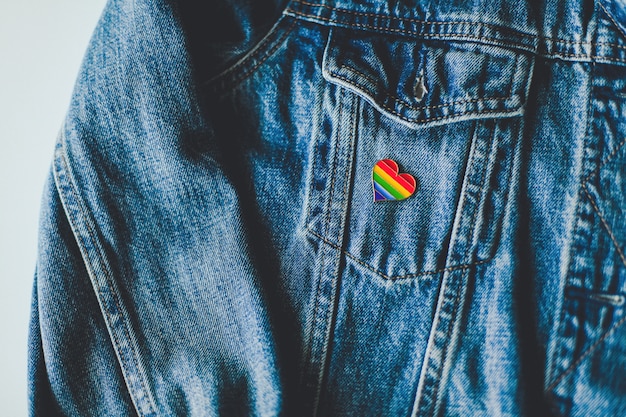 Rainbow flag pin on a blue jacket