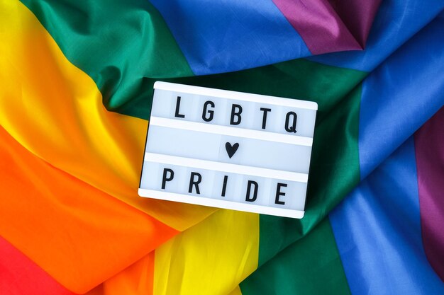 Rainbow flag with lightbox and text lgbtq pride rainbow lgbtq flag made from silk material symbol