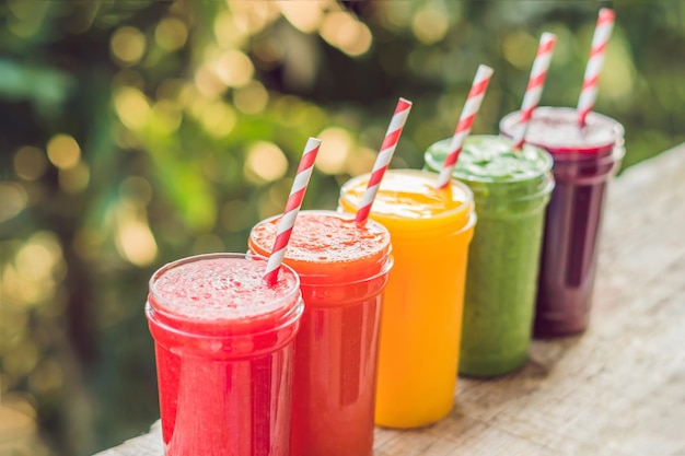 Rainbow from smoothies. Watermelon, papaya, mango, spinach and dragon fruit. Smoothies, juices, beverages, drinks variety with fresh fruits on a wooden table