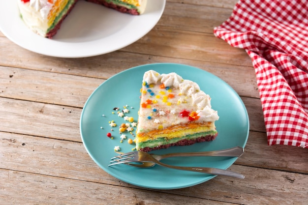 Rainbow layer cake on wooden table