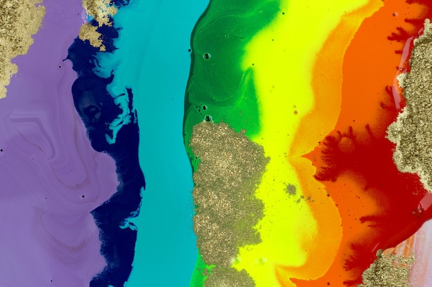 Текстура жидких акриловых чернил радуги с золотой пылью