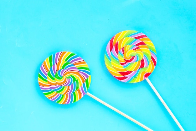 Rainbow lollipop on blue background