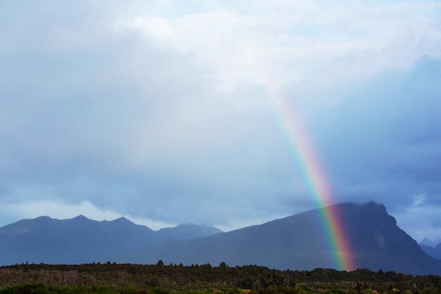 Rainbow above mountains. Beautiful natural landscapes. Picturesque nature.