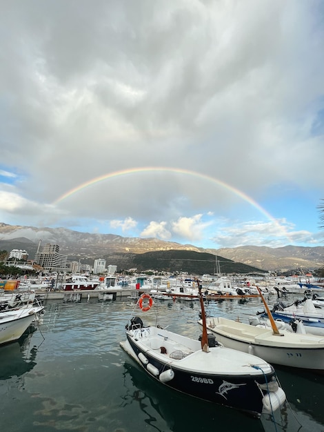 Rainbow in the sky over the mountains above the marina