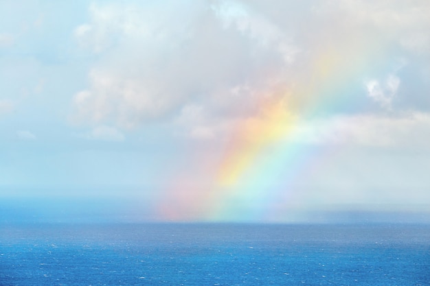 Rainbow starting from the sea in Madeira Portugal