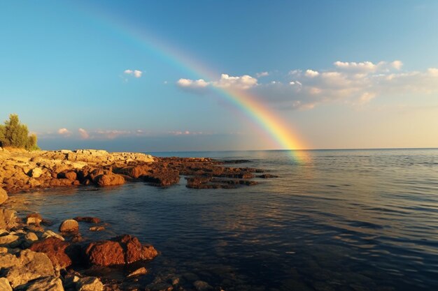 Rainbow over stony seacoast