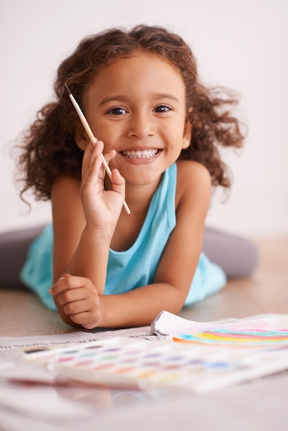 Rainbows are my favorite thing in the whole world Shot of a little girl painting a picture of a rainbow