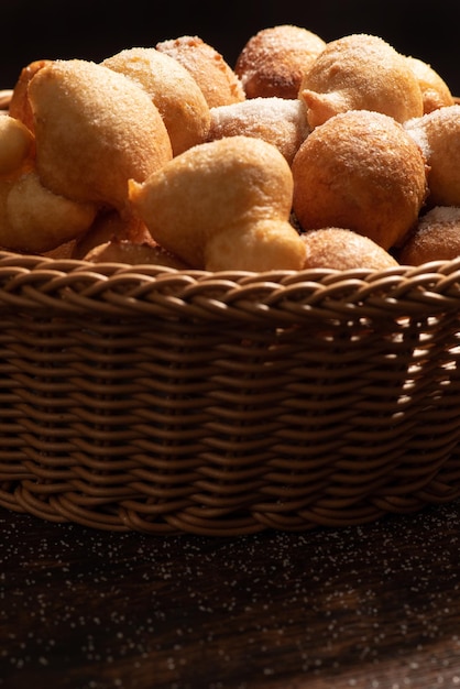 Raincake basket with raincakes on rustic wood with black background selective focus