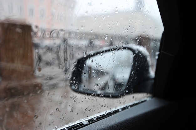 Raindrops on the car rear view mirror