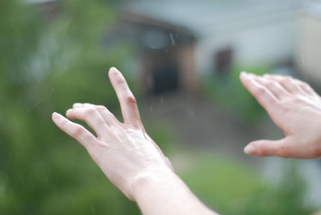 The raindrops falling on the woman's hands