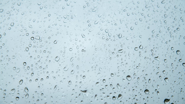 Raindrops on glass against the sky