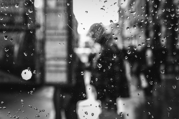 Raindrops on glass by bus stop