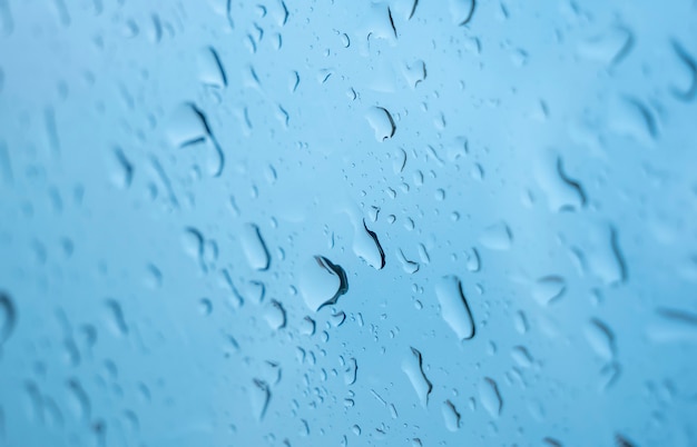 Raindrops on the window. Blue tone