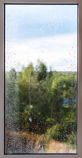 Raindrops on the window The concept of rainy weather The texture of the rain