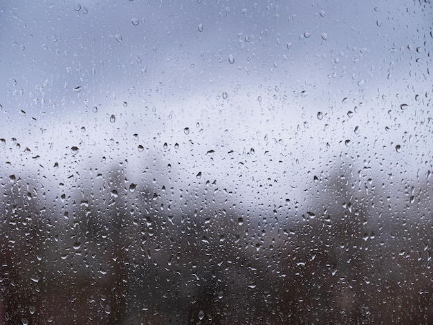 Raindrops on window glass autumn season