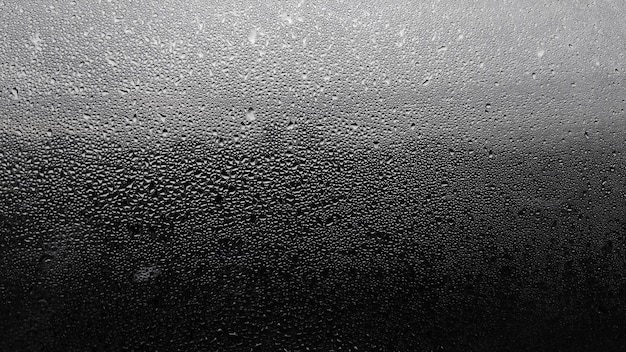 Raindrops on the window with sky background.