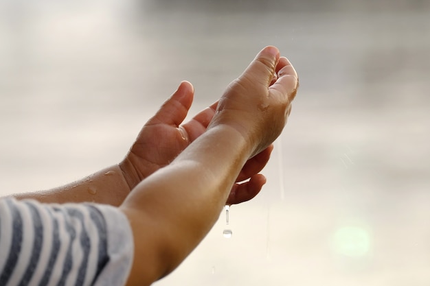 Raining into children's hands.