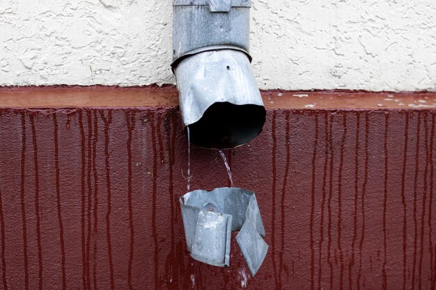 Rainwater pours from the sewer close up